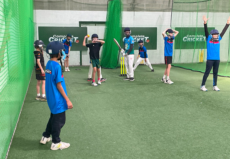 Young players practicing catching drills during a cricket skill clinic for ages 7-16 at Complete Cricket.